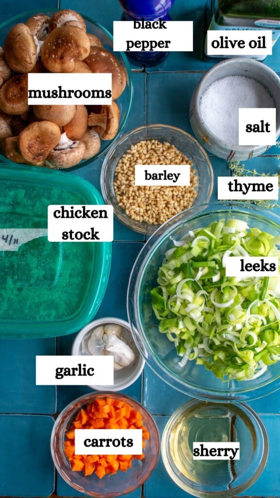 All the ingredients to make barley soup including barley, chicken stock, olive oil, and more. 