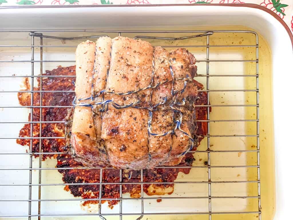 pork roast on a wire rack over a roasting pan. 