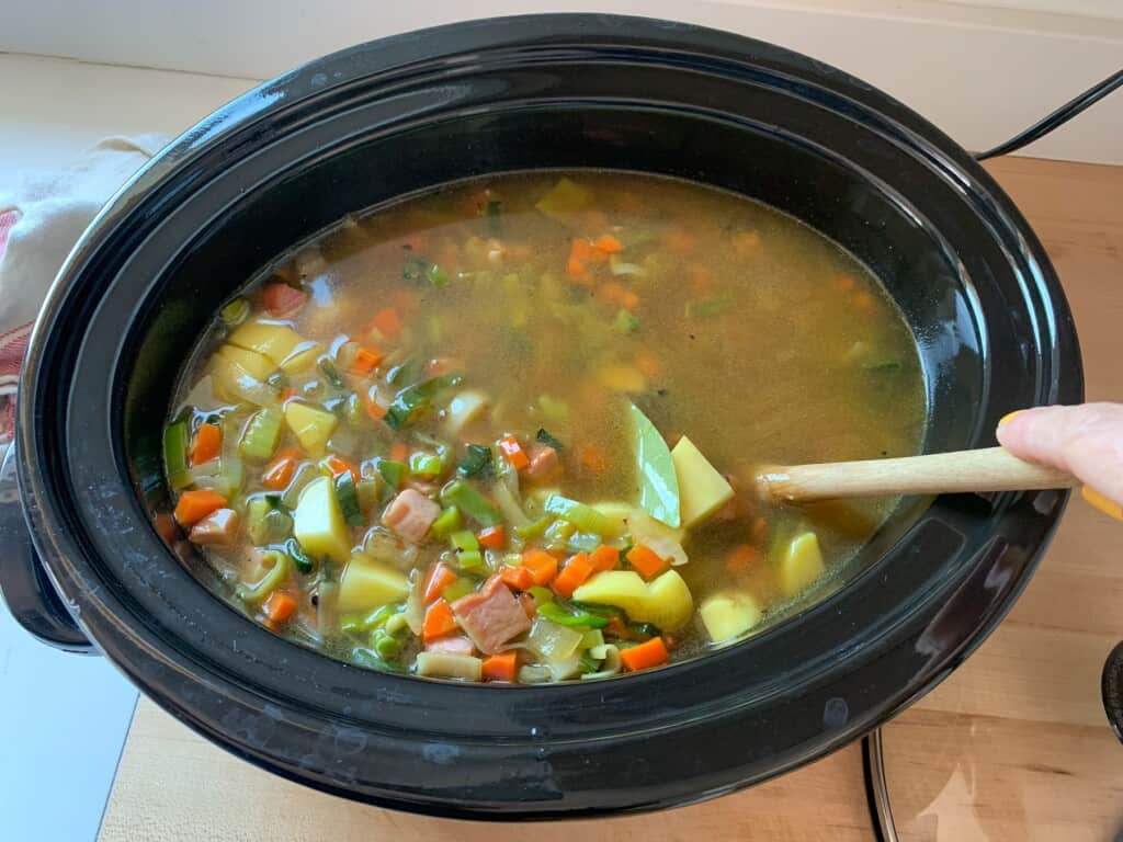 Split pea and ham soup cooking in a slow cooker. 