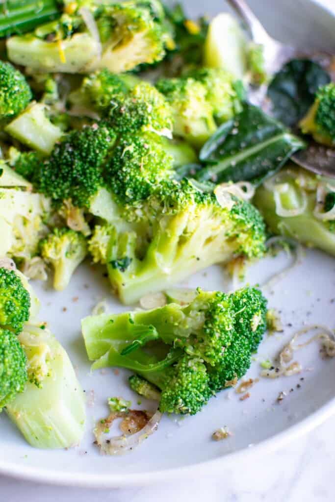 A plate of broccoli with shallots and garlic. 