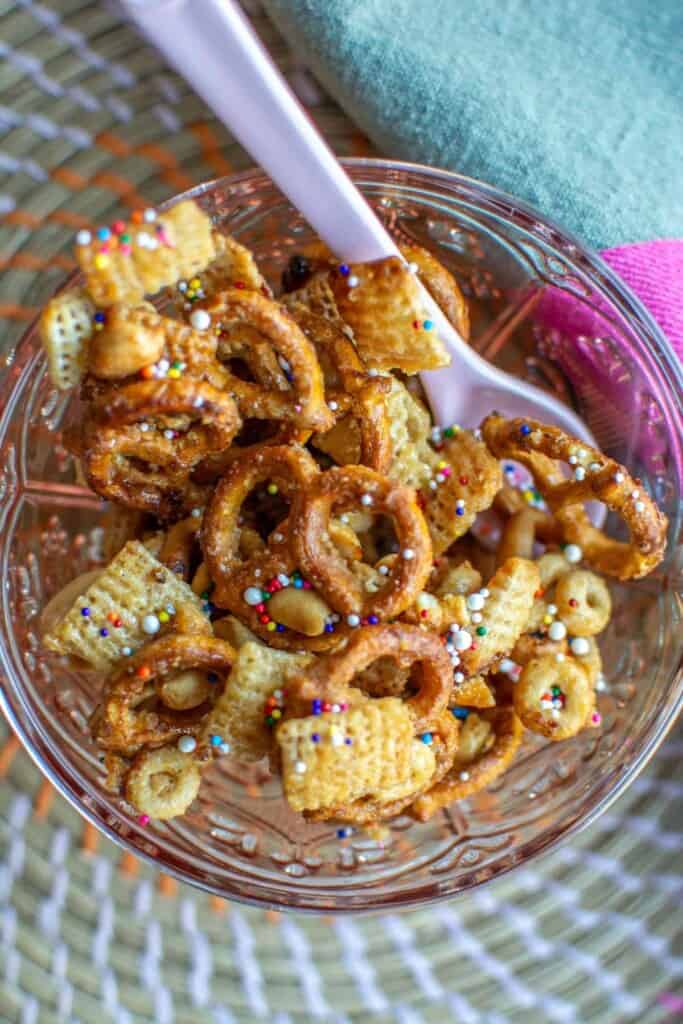 a mix of pretzels and crackers in a bowl