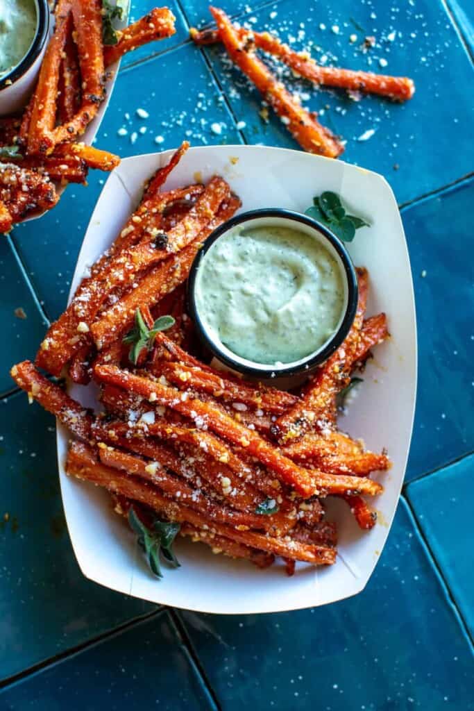 oven baked carrot fries sprinkled with parmesan and Pesto Aioli