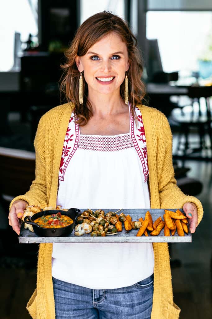 Picture of a woman holding a tray of food 