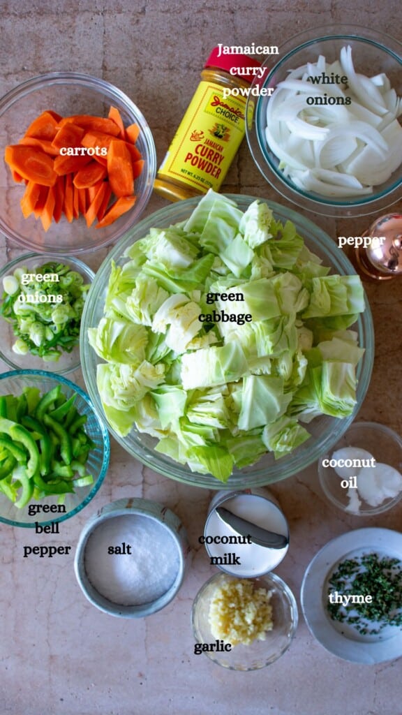 All the ingredients to make Jamaican curried cabbage including cabbage, carrots, curry powder, and more. 