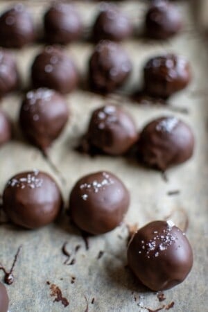 Several chocolate truffles on a sheet pan