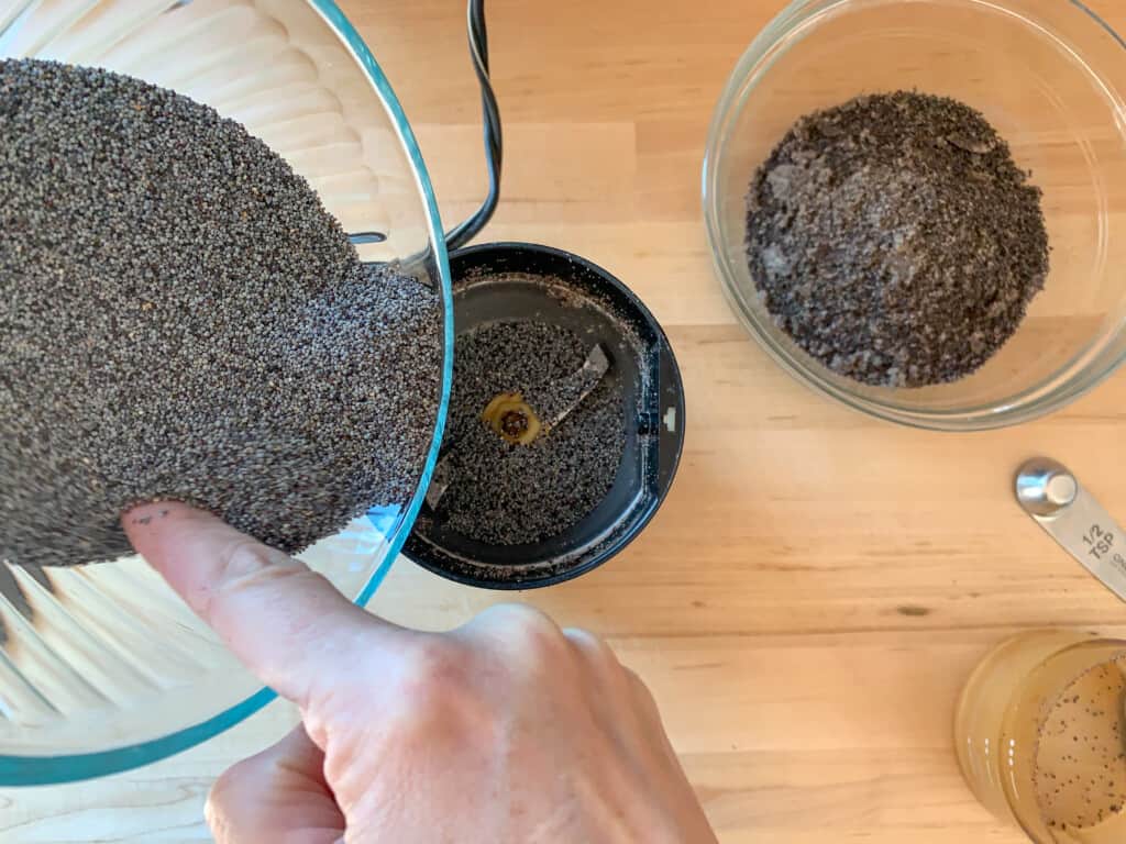 poppy seeds being ground in a spice grinder