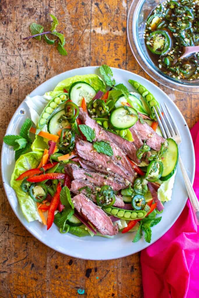 A thai-style steak salad with thin slices of steak, peppers, and more. 