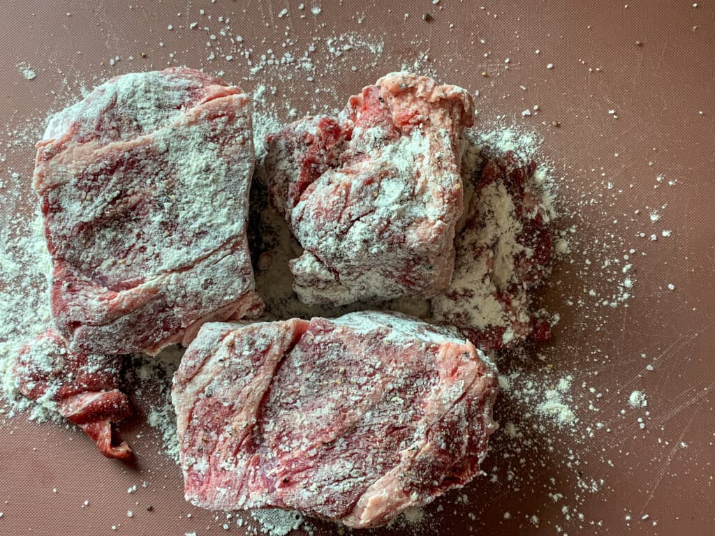 A few pieces of beef dusted with flour and salt and pepper. 