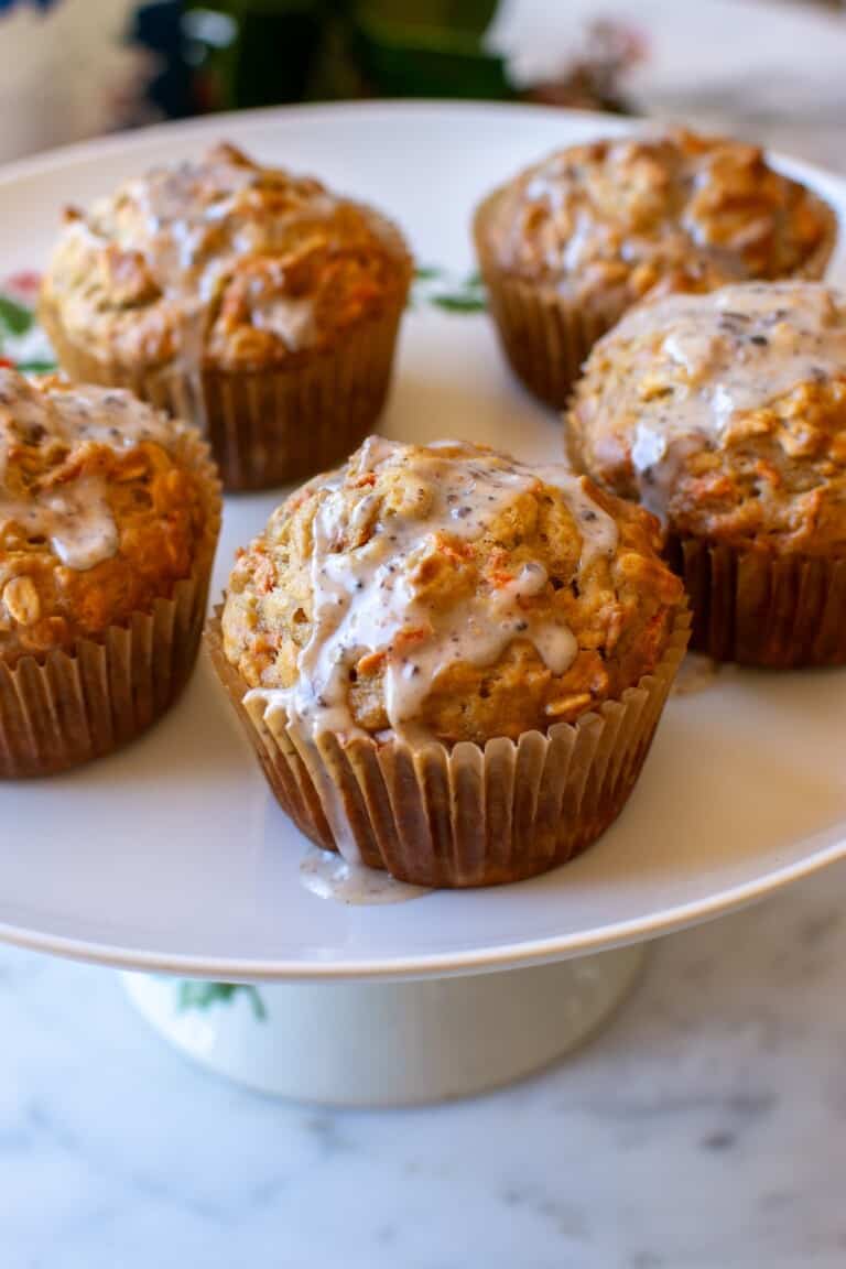 apple oatmeal muffins recipe on a white cake stand.