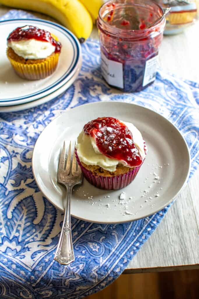 Banana cupcakes on a plate with a fork next to one. 