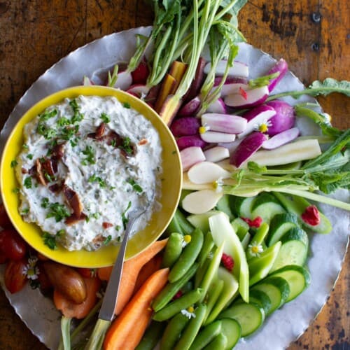 bacon blue cheese dip with veggies on a silver tray.