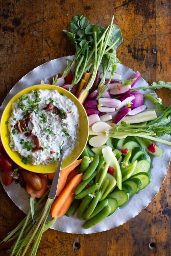 bacon blue cheese dip with veggies on a silver tray. 