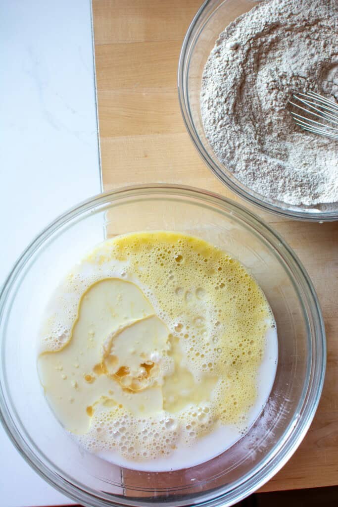 The wet ingredients in a glass bowl to make the waffles. 