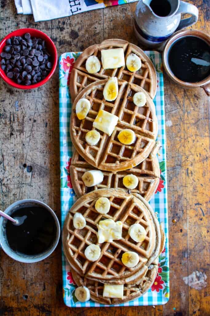 Several whole wheat waffles on a blue tray