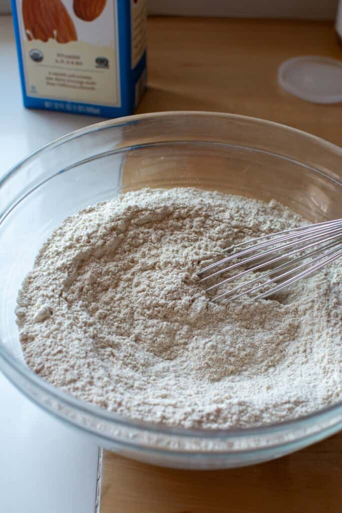 All the dry ingredients for the waffles in a glass bowl. 