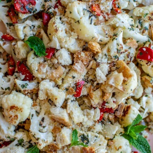 A close up of roasted cauliflower with pickled cherry peppers