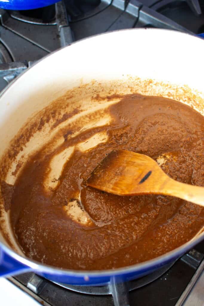 roux cooking in the pot with a wood spoon stirring