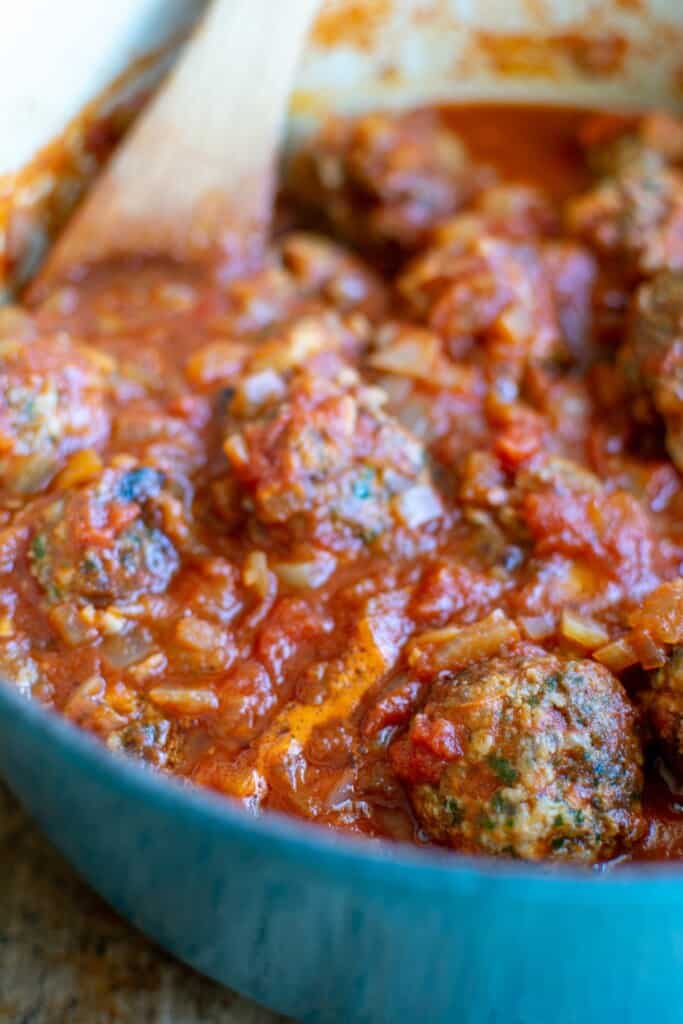 Meatballs in sauce in the blue pot. 