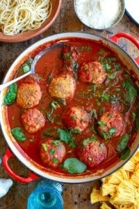 A pot of chicken meatballs with a spoon in the pot