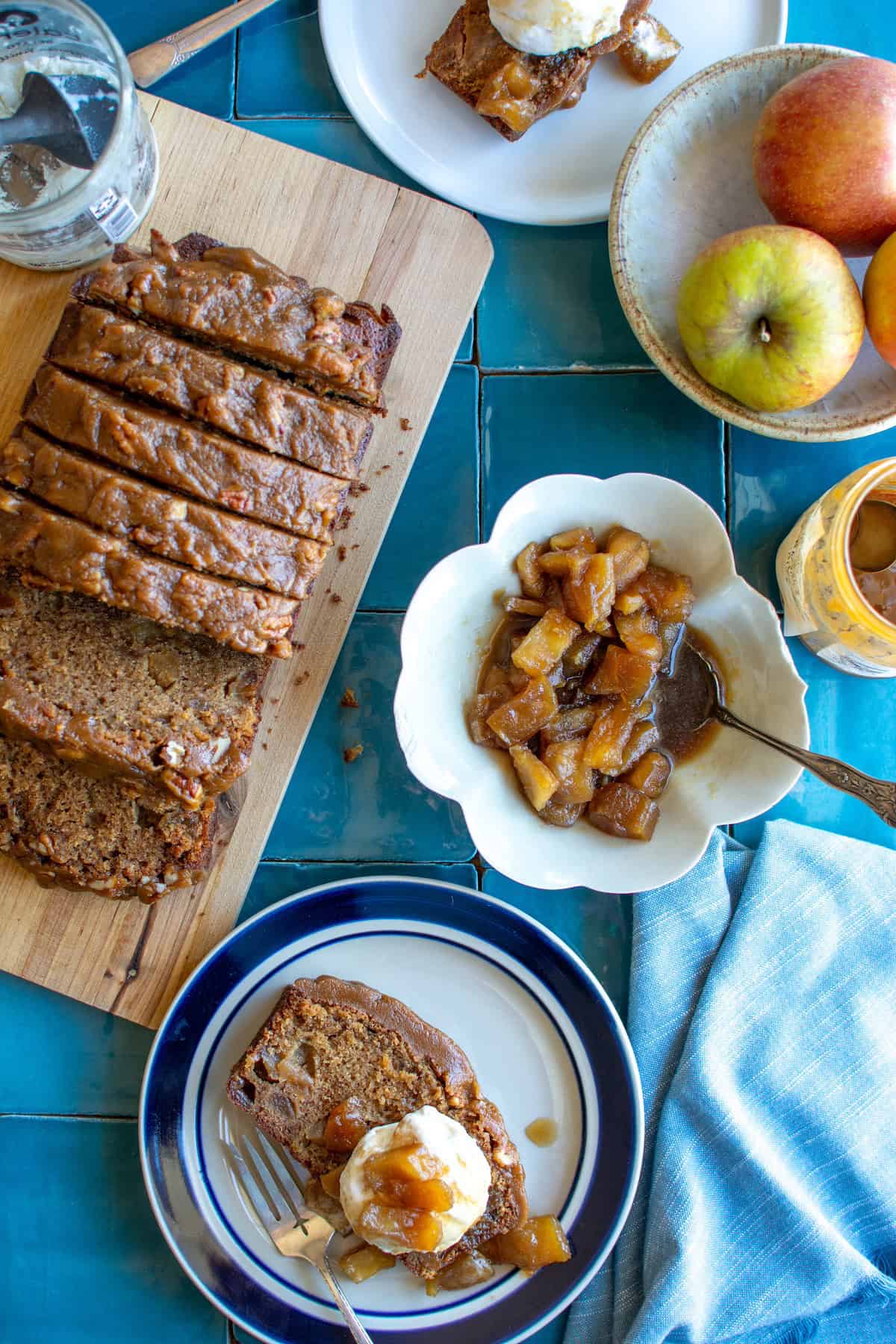 A caramel apple pound cake with two slices on plates with ice cream on top