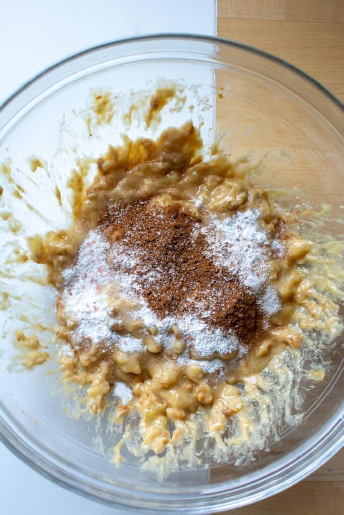 spices on top of mashed bananas in a bowl