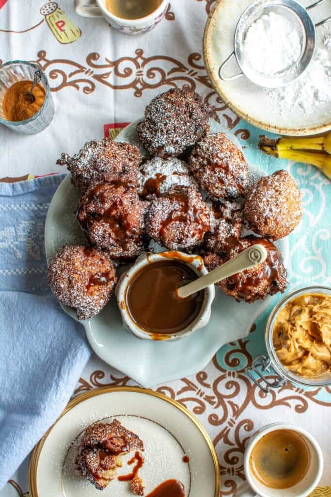 A plate of peanut butter banana fritters with coffee caramel sauce