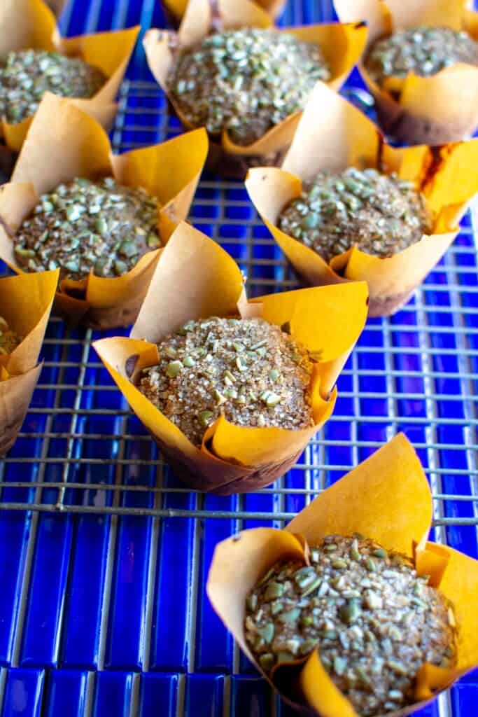 several pumpkin seed muffins on a blue tile table