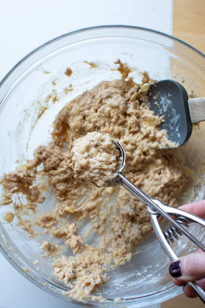 A cookie scoop scooping the dough