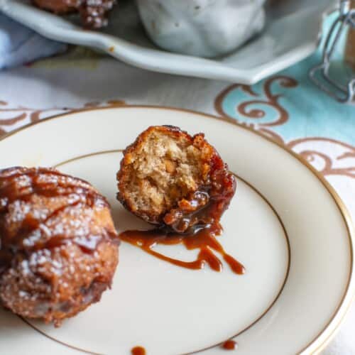 A peanut butter banana fritter with caramel sauce on it.