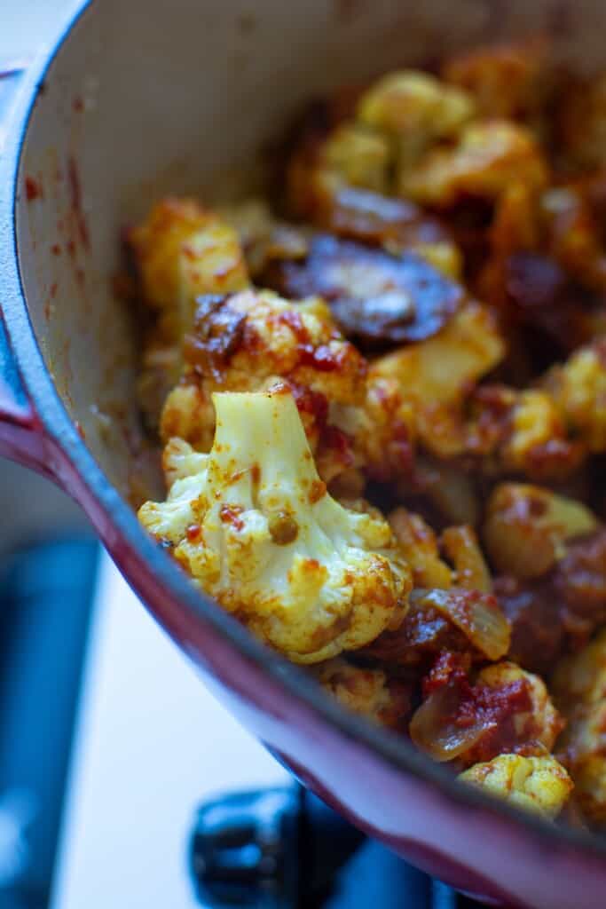 Cauliflower in the pot after the curry has been added