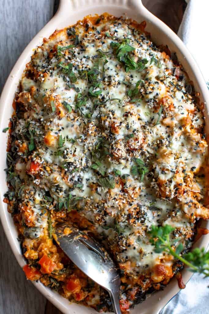 The ground turkey casserole with a spoon digging into the casserole