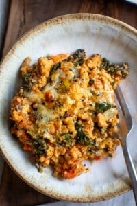 A bowl with a serving of ground turkey casserole in it and a fork