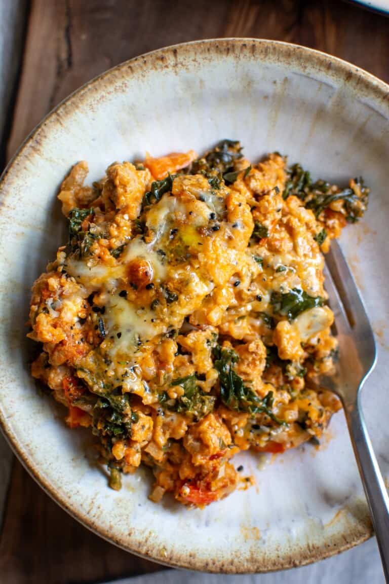 A bowl with a serving of ground turkey casserole in it and a fork
