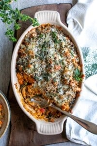 A casserole dish filled with ground turkey casserole with a spoon in it