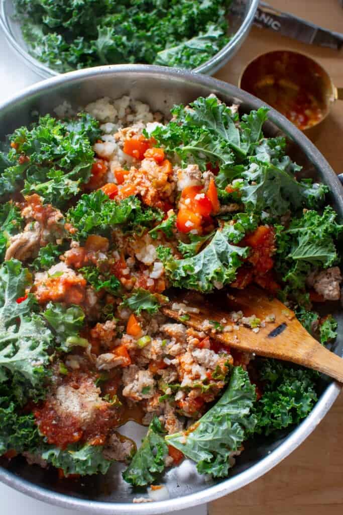 Ground turkey sautéed with kale in a pan