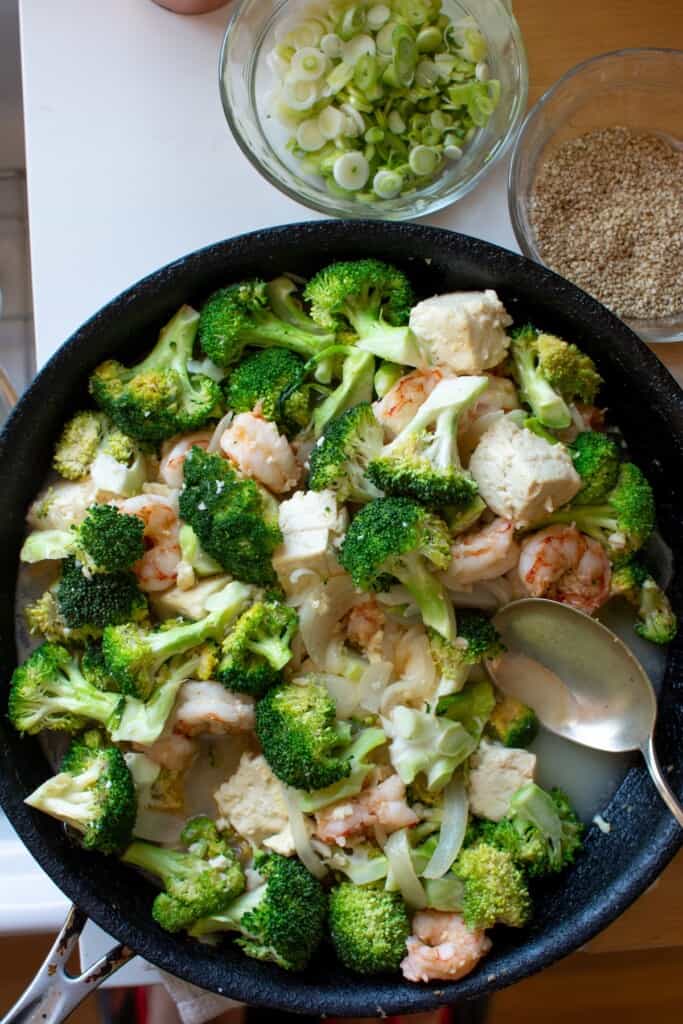 Tofu and broccoli in a large frying pan