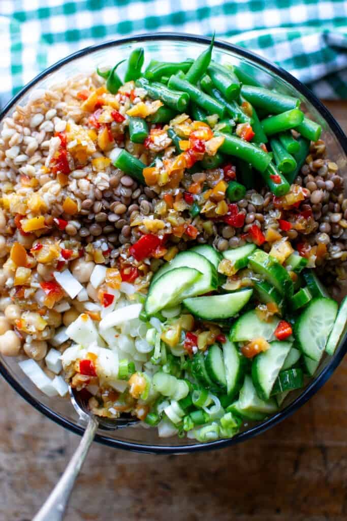 A grain and beans salad topped with cherry pepper dressing.