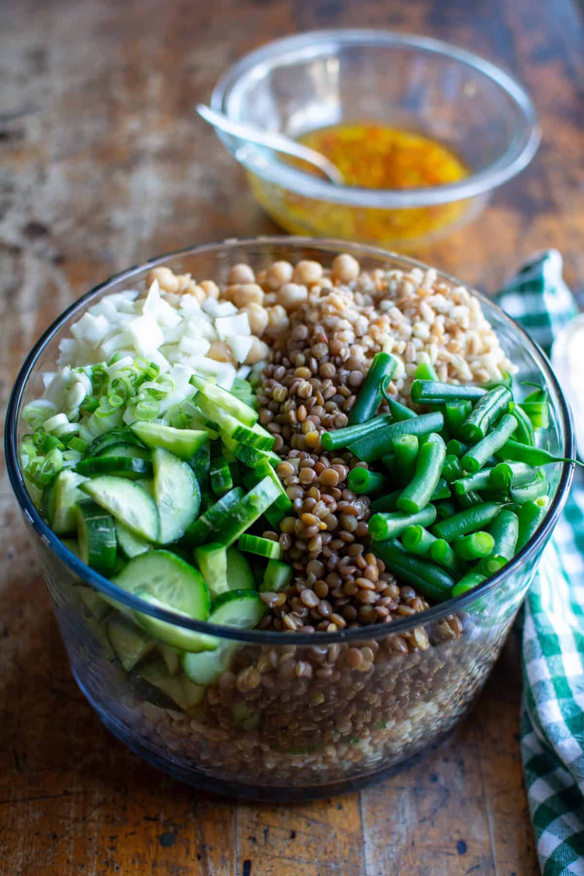 A glass bowl filled with grain and bean salad.