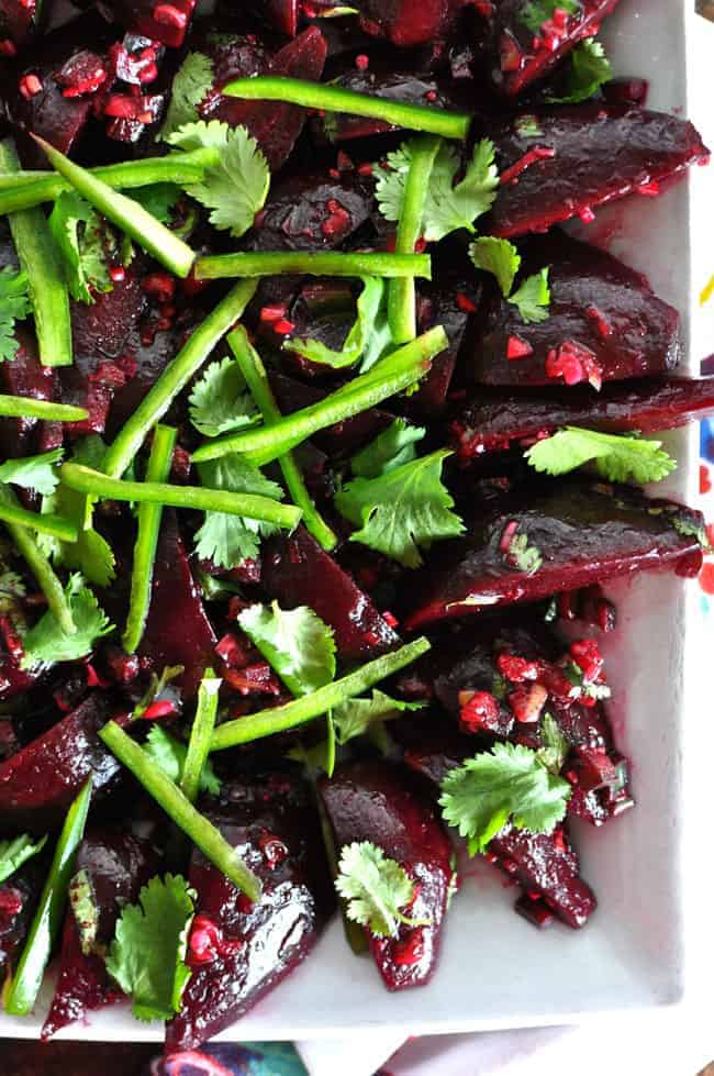 a beet salad with green chiles on top