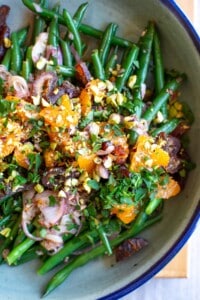 The green bean recipe in a bowl topped with dates