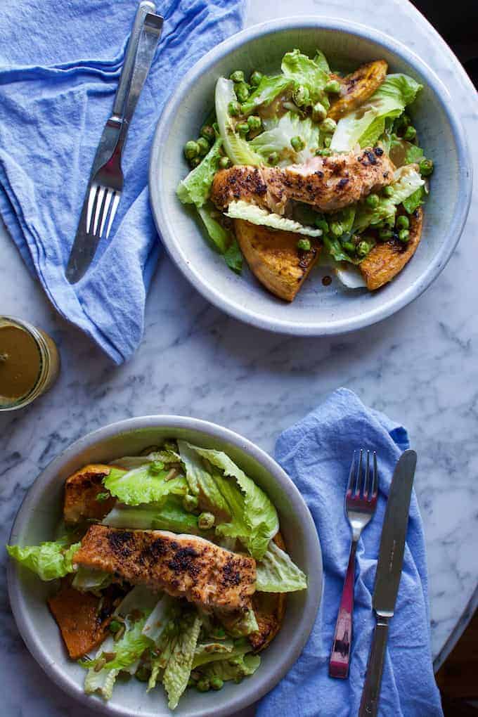 two dishes of salad with blue napkins