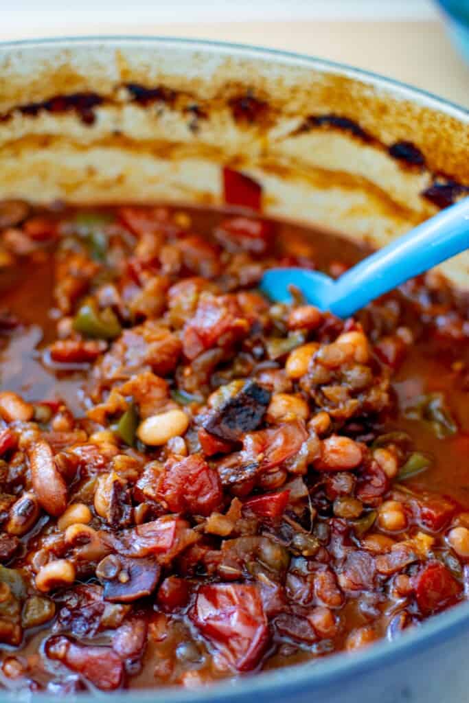 baked beans in a pot with a blue spoon