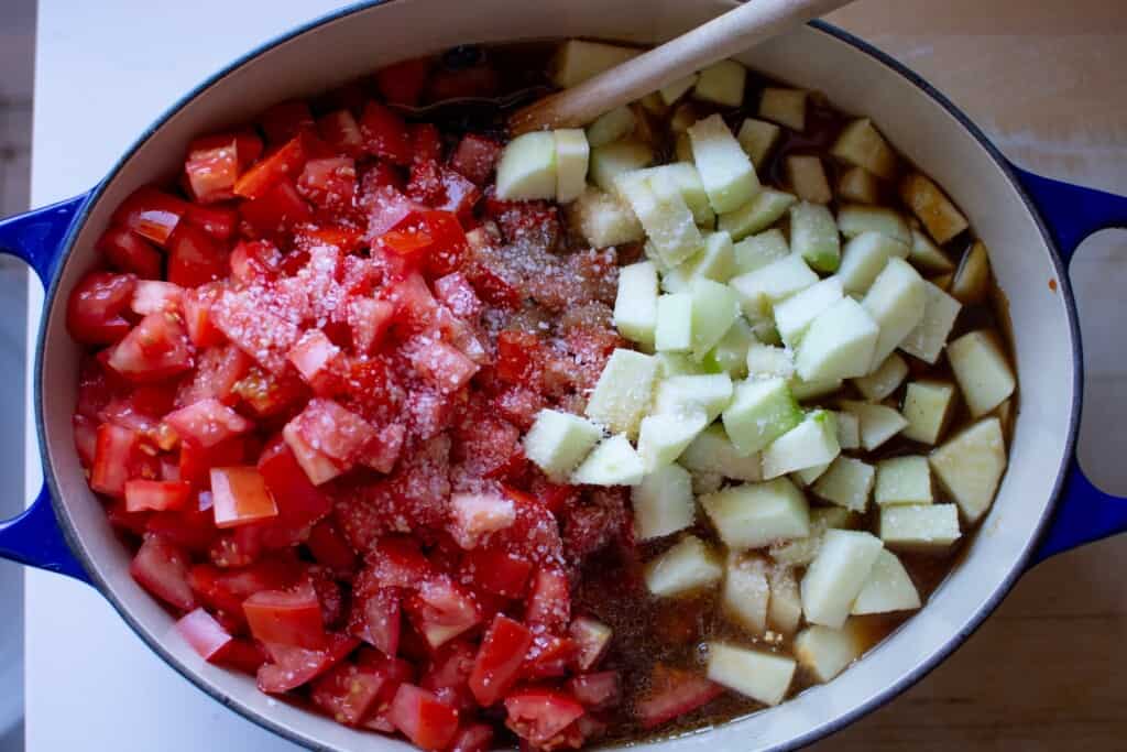apples and tomatoes on top of the beans
