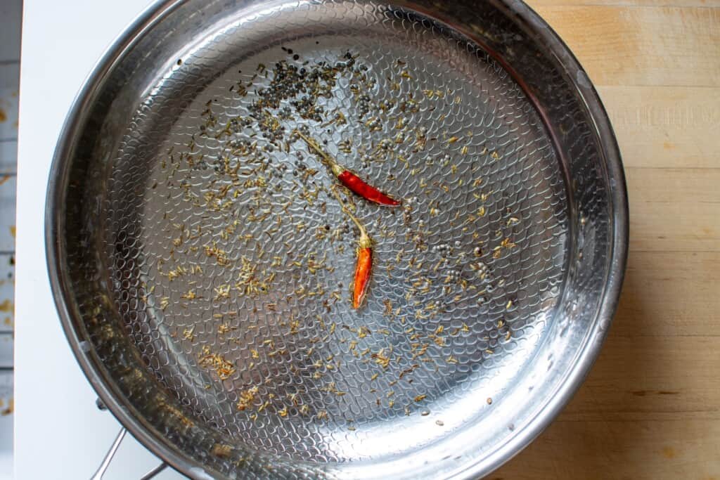 spices blooming in a frying pan