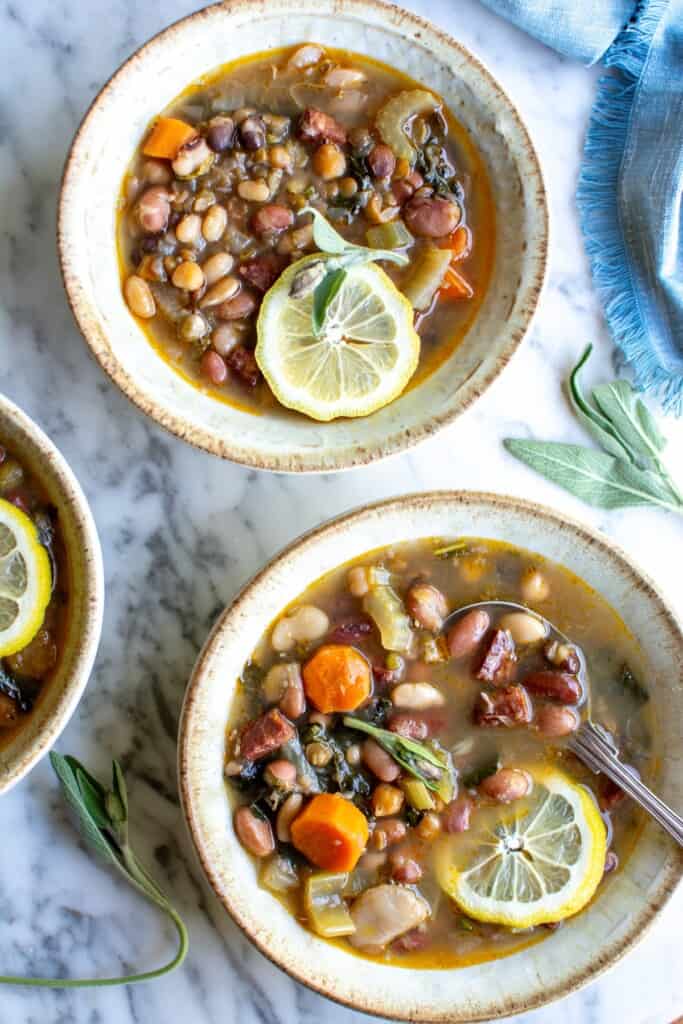 15 bean soup in 3 bowls with lemon slices