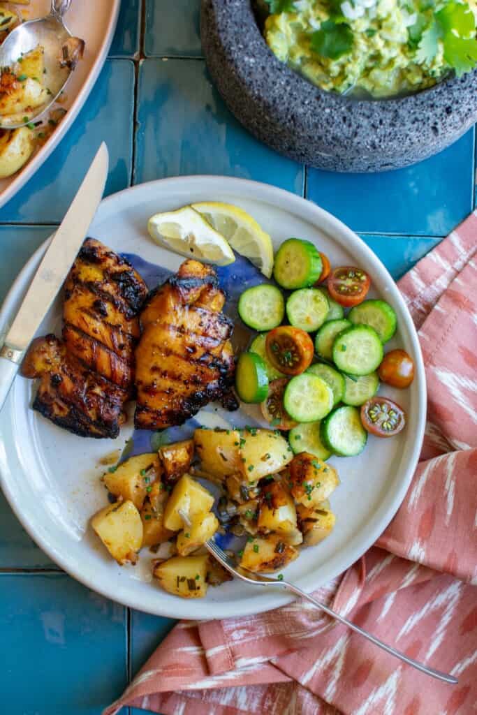grilled chicken on a plate with grilled potatoes