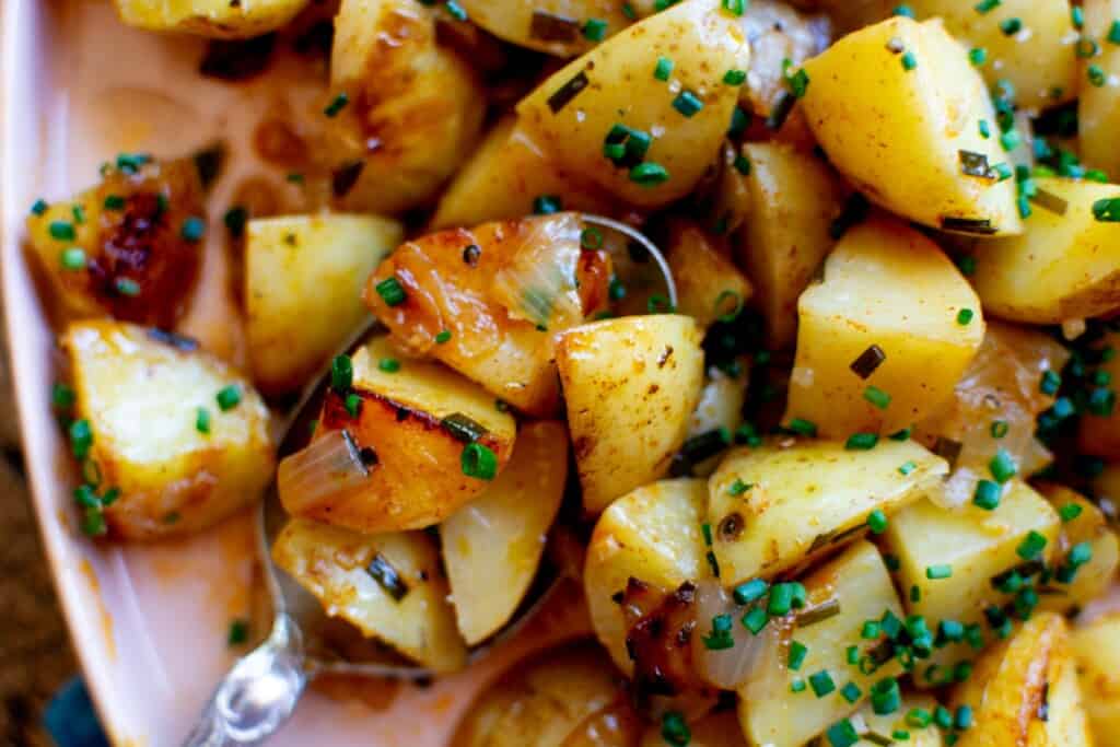 grilled potatoes with a serving spoon