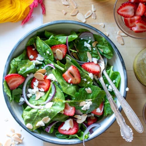 A spinach salad with strawberries