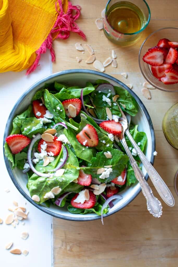 A spinach salad with strawberries