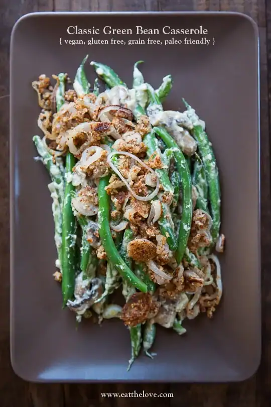 creamy green beans topped with onions in a brown plate